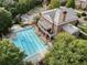 Aerial view of a large outdoor swimming pool with lounge chairs, and a brick clubhouse with balconies at 6430 Banbury Se Ct, Mableton, GA 30126