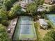 Aerial view of a tennis court, playground, and gazebo surrounded by lush greenery and community buildings at 6430 Banbury Se Ct, Mableton, GA 30126