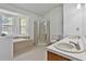 Bright bathroom boasts double sinks, large tub, and glass shower, offering plenty of space at 100 Walnut Ct, Stockbridge, GA 30281