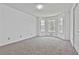 Spacious bedroom with plush carpet and bay windows, providing ample natural light and a cozy atmosphere at 100 Walnut Ct, Stockbridge, GA 30281