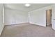 An empty room featuring plush carpeting, a neutral color palette, and ample space for customization at 100 Walnut Ct, Stockbridge, GA 30281