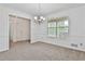 Open dining room featuring chair rail, neutral carpet, and view to a doorway at 100 Walnut Ct, Stockbridge, GA 30281