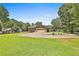 Charming single-Gathering home featuring a well-manicured lawn and inviting circular driveway at 100 Walnut Ct, Stockbridge, GA 30281