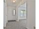 Bright foyer featuring neutral carpet and a view into a room with large window at 100 Walnut Ct, Stockbridge, GA 30281