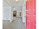 Inviting foyer featuring a stone fireplace, neutral carpet, and open view to living area at 100 Walnut Ct, Stockbridge, GA 30281