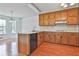 Functional kitchen featuring wood cabinets, white countertops, and hardwood floors at 100 Walnut Ct, Stockbridge, GA 30281