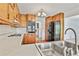 View of kitchen boasting stainless steel appliances, light countertops, double basin sink, and wood cabinets at 100 Walnut Ct, Stockbridge, GA 30281