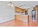 Functional kitchen with breakfast nook featuring wood floors, island, and modern appliances at 100 Walnut Ct, Stockbridge, GA 30281