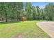Well-maintained yard features lush green grass, mature trees, and a white picket fence, creating a serene outdoor space at 100 Walnut Ct, Stockbridge, GA 30281