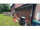 Large backyard with a wooden deck and brick exterior with mature trees at 1095 Mitchell Crossing Sw Dr, Atlanta, GA 30331