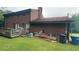 Backyard featuring a wooden deck, lawn and mature trees, perfect for outdoor activities at 1095 Mitchell Crossing Sw Dr, Atlanta, GA 30331