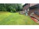 Expansive backyard featuring a wooden deck, lawn and mature trees, perfect for outdoor living at 1095 Mitchell Crossing Sw Dr, Atlanta, GA 30331
