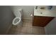 Compact bathroom with tiled floor, toilet, and vanity with storage at 1095 Mitchell Crossing Sw Dr, Atlanta, GA 30331