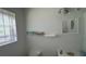 Bathroom with a window, a white toilet, and a small vanity with a mirror at 1095 Mitchell Crossing Sw Dr, Atlanta, GA 30331