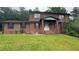 Charming two-story brick home with covered front porch and a lush green lawn at 1095 Mitchell Crossing Sw Dr, Atlanta, GA 30331