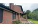 Brick exterior of a two-story home with black trim and mature trees at 1095 Mitchell Crossing Sw Dr, Atlanta, GA 30331