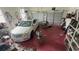 Spacious garage with a white car, storage shelves, and multiple doors at 1095 Mitchell Crossing Sw Dr, Atlanta, GA 30331