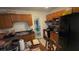 Kitchen with wood cabinets, a black refrigerator, and a view to a dining area at 1095 Mitchell Crossing Sw Dr, Atlanta, GA 30331