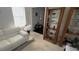 Bright living room with white sofa and a wooden display cabinet with shelves at 1095 Mitchell Crossing Sw Dr, Atlanta, GA 30331