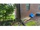 This shows the home's brick exterior and side yard with some landscaping and lawn at 1095 Mitchell Crossing Sw Dr, Atlanta, GA 30331