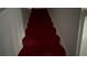 Carpeted staircase with a red runner leading to the upper level at 1095 Mitchell Crossing Sw Dr, Atlanta, GA 30331
