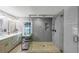 Modern bathroom featuring dual vanity, glass enclosed shower with pebble floor and rainfall showerhead at 2123 Garden Cir, Decatur, GA 30032