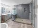 Modern bathroom featuring dual vanity, glass enclosed shower with pebble floor and rainfall showerhead at 2123 Garden Cir, Decatur, GA 30032