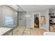 Bright bathroom featuring glass enclosed shower with pebble floor, rainfall showerhead and linen storage at 2123 Garden Cir, Decatur, GA 30032