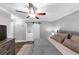 Large bedroom featuring a ceiling fan, TV, and a barn door to the bathroom at 2123 Garden Cir, Decatur, GA 30032