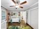 Bright Bedroom featuring a crib, dresser, and windows offering views of the landscaped yard at 2123 Garden Cir, Decatur, GA 30032