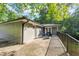 Exterior view of home featuring an outdoor patio surrounded by lush greenery and nature at 2123 Garden Cir, Decatur, GA 30032