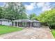Well-maintained single-story house with a spacious driveway and inviting front porch amid mature trees at 2123 Garden Cir, Decatur, GA 30032