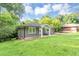 Single story home with a lush front lawn, mature landscaping, and an inviting front porch with chairs at 2123 Garden Cir, Decatur, GA 30032