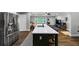 Open kitchen with island, stainless steel fridge, and hardwood floors at 2123 Garden Cir, Decatur, GA 30032