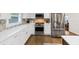 Modern kitchen with stainless steel appliances, white cabinets, and hardwood floors at 2123 Garden Cir, Decatur, GA 30032