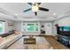 Spacious living room featuring hardwood floors, tray ceilings, large windows, and an airy open design at 2123 Garden Cir, Decatur, GA 30032