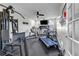 Well-equipped home gym featuring a treadmill, elliptical, and multi-station weight machine for convenient workouts at 22107 Harvest Ridge Lane # 22, Alpharetta, GA 30022