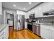 Modern kitchen with stainless steel appliances, white cabinets, and granite countertops at 22107 Harvest Ridge Lane # 22, Alpharetta, GA 30022