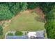 Aerial view of the perfectly manicured and verdant backyard including the patio with outdoor seating at 3030 Larkspur Ct, Cumming, GA 30041