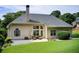 Backyard featuring a patio with seating, lush lawn, and mature landscaping for outdoor enjoyment at 3030 Larkspur Ct, Cumming, GA 30041