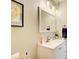 Bathroom vanity features a white cabinet, stylish mirror, and modern lighting fixtures at 3030 Larkspur Ct, Cumming, GA 30041