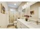 Bright bathroom with dual sinks, vanity, modern fixtures and decorative mirrors at 3030 Larkspur Ct, Cumming, GA 30041