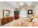 Bright bedroom features tray ceilings, large window, and ample dresser space at 3030 Larkspur Ct, Cumming, GA 30041