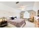 Vaulted ceiling bedroom with a ceiling fan, windows, dresser, and two chairs at 3030 Larkspur Ct, Cumming, GA 30041