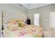 Bedroom showcasing tufted headboard and access to Primary bath at 3030 Larkspur Ct, Cumming, GA 30041