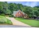 Attractive home features a brick facade, lush landscaping, and a long driveway at 3030 Larkspur Ct, Cumming, GA 30041