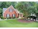 Charming brick home with well-manicured lawn and mature trees offering curb appeal at 3030 Larkspur Ct, Cumming, GA 30041