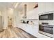 Modern kitchen boasts stainless steel appliances, white cabinets, and stylish countertops at 3030 Larkspur Ct, Cumming, GA 30041