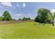 Spacious backyard featuring a fire pit, chairs, and a wood fence for relaxing and entertaining at 3153 Morgan Box Ne Ln, Buford, GA 30519