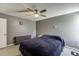 Bedroom featuring a bed with blue bedding, a ceiling fan, a dresser and a window at 3153 Morgan Box Ne Ln, Buford, GA 30519
